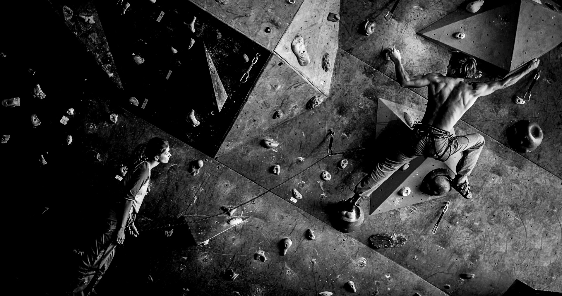 Black and white image showing a man bouldering